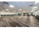Large meeting room with wood-look floors, fireplace, and convenient access to a kitchen and recreational area at 2212 Portside Psge, Palm Harbor, FL 34685