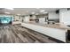 Meeting room highlighting breakfast bar with modern appliances, long wood-look floors, and speakers at 2212 Portside Psge, Palm Harbor, FL 34685