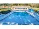 Community pool and sundeck with seating and tables at 2212 Portside Psge, Palm Harbor, FL 34685