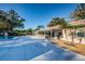 Community pool area featuring ample patio seating, a covered lounge and lush landscaping at 2212 Portside Psge, Palm Harbor, FL 34685