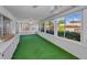 Enclosed sun room has bright green carpet and slider windows at 2212 Portside Psge, Palm Harbor, FL 34685