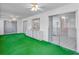 Enclosed sun room has bright green carpet and slider windows at 2212 Portside Psge, Palm Harbor, FL 34685