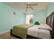 Charming bedroom with green walls, a comfortable bed, and a bright window view at 255 114Th N Ave # 4, St Petersburg, FL 33716