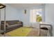 Bright bedroom with a sofa, a soccer-themed rug, and a desk near the window at 255 114Th N Ave # 4, St Petersburg, FL 33716