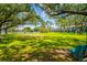 A lush community park with mature trees and a bench, offering a tranquil place for residents at 255 114Th N Ave # 4, St Petersburg, FL 33716