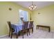 Bright dining area features tiled floors, table with seating for four, and a bench at 255 114Th N Ave # 4, St Petersburg, FL 33716