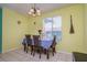 Bright dining room features tiled floors, a modern chandelier and dining table seating four at 255 114Th N Ave # 4, St Petersburg, FL 33716