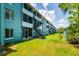Three story condo buildings with stairs, balconies and green space at 255 114Th N Ave # 4, St Petersburg, FL 33716