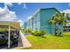 Exterior shot of the condo buildings near parking area, gardens and tropical foliage at 255 114Th N Ave # 4, St Petersburg, FL 33716
