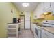 This kitchen is equipped with white appliances and white cabinets offering lots of storage space at 255 114Th N Ave # 4, St Petersburg, FL 33716