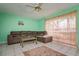 A view of the living room with a brown sectional sofa, tile floors and a view of the outdoor patio at 255 114Th N Ave # 4, St Petersburg, FL 33716