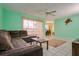 A view of the living room with a brown sectional sofa, a ceiling fan and a dining room is visible at 255 114Th N Ave # 4, St Petersburg, FL 33716