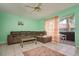 A view of the living room with a brown sectional sofa, tile floors and a view of the outdoor patio at 255 114Th N Ave # 4, St Petersburg, FL 33716