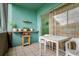 A view of the outdoor patio with tiled floors, a white table, two white chairs and a shelf of plants at 255 114Th N Ave # 4, St Petersburg, FL 33716