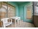 Screened patio with tile flooring, seating, and view to stairwell at 255 114Th N Ave # 4, St Petersburg, FL 33716