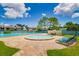 A relaxing pool area with a hot tub and pool surrounded by plenty of deck chairs to enjoy under the sunshine at 255 114Th N Ave # 4, St Petersburg, FL 33716