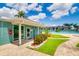 A charming pool house adjacent to a sparkling community pool, featuring tiled flooring, and a manicured lawn at 255 114Th N Ave # 4, St Petersburg, FL 33716