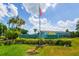 An inviting entrance sign to the condominiums of Windward Pointe with lush landscaping and an American flag waving proudly at 255 114Th N Ave # 4, St Petersburg, FL 33716
