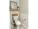 This half bathroom features neutral colors, a floating shelf, and framed artwork at 2717 Chestnut Creek Pl, Brandon, FL 33510
