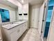 This bright bathroom features double sinks, a granite countertop, and an open doorway to the bedroom at 2717 Chestnut Creek Pl, Brandon, FL 33510