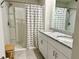 This bathroom has a double vanity, a shower, and a tub with a white shower curtain at 2717 Chestnut Creek Pl, Brandon, FL 33510