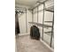 This walk-in closet is complete with carpeted floors and built-in shelving units for storage at 2717 Chestnut Creek Pl, Brandon, FL 33510