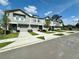 Beautiful exterior view of well-maintained townhomes, each with a private driveway and manicured lawn at 2717 Chestnut Creek Pl, Brandon, FL 33510