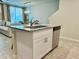 Kitchen island featuring granite countertops, stainless steel dishwasher, and a stainless steel faucet at 2717 Chestnut Creek Pl, Brandon, FL 33510