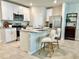 Modern kitchen with stainless steel appliances, a granite countertop island, and white cabinetry at 2717 Chestnut Creek Pl, Brandon, FL 33510
