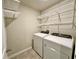 Convenient laundry room featuring a washer, dryer, and ample storage with shelving and overhead racks at 2717 Chestnut Creek Pl, Brandon, FL 33510