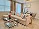 Living room features a modern sofa, glass coffee table, and elegant dining set at 2717 Chestnut Creek Pl, Brandon, FL 33510
