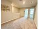 A large carpeted loft features neutral walls and trim with an open hallway leading to bedrooms and bathrooms at 2717 Chestnut Creek Pl, Brandon, FL 33510