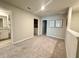 A carpeted loft space leads to the bathroom and laundry room, complete with recessed lighting and artwork at 2717 Chestnut Creek Pl, Brandon, FL 33510