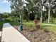 Beautifully landscaped walking path with mature trees and shrubs, providing a tranquil outdoor space at 2717 Chestnut Creek Pl, Brandon, FL 33510