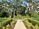 Scenic walking path with lush landscaping and mature trees for a peaceful outdoor experience at 2717 Chestnut Creek Pl, Brandon, FL 33510