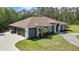 An aerial perspective of the house with a large lawn with mature trees at 27338 Elkwood Cir, Wesley Chapel, FL 33544