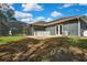 Lush backyard featuring a home with a screened-in pool, creating an ideal space for outdoor relaxation and enjoyment at 27338 Elkwood Cir, Wesley Chapel, FL 33544