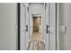 Hallway view of a bathroom featuring a large walk-in shower with natural stone and sliding barn doors for privacy at 27338 Elkwood Cir, Wesley Chapel, FL 33544