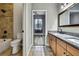 Bathroom with tiled shower and double sink at 27338 Elkwood Cir, Wesley Chapel, FL 33544