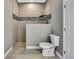 Beautiful bathroom featuring a toilet, walk-in shower with mosaic tile accent, and modern fixtures at 27338 Elkwood Cir, Wesley Chapel, FL 33544