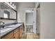 Bathroom featuring double sinks and wood cabinets at 27338 Elkwood Cir, Wesley Chapel, FL 33544