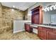 Luxurious bathroom featuring a walk-in shower with a large rainfall shower head and dual sinks with granite countertops at 27338 Elkwood Cir, Wesley Chapel, FL 33544