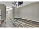 Spacious bedroom showcasing modern ceiling fan, neutral walls, and stylish wood-look floors at 27338 Elkwood Cir, Wesley Chapel, FL 33544