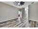 Large bedroom features wood-look flooring, neutral paint, and multiple doors at 27338 Elkwood Cir, Wesley Chapel, FL 33544