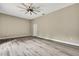 Bright bedroom featuring wood-look floors, a modern ceiling fan, and neutral walls providing a calming atmosphere at 27338 Elkwood Cir, Wesley Chapel, FL 33544