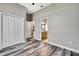 Bedroom with hardwood floors leads to bathroom with wood vanity at 27338 Elkwood Cir, Wesley Chapel, FL 33544