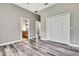 Bedroom with hardwood floors leads to bathroom with wood vanity at 27338 Elkwood Cir, Wesley Chapel, FL 33544