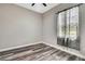 Neutral bedroom with hardwood floors and patterned curtains at 27338 Elkwood Cir, Wesley Chapel, FL 33544
