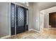 Elegant entryway with decorative glass door, tile floor and neutral colored walls at 27338 Elkwood Cir, Wesley Chapel, FL 33544