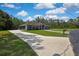 Wide angle shot of a home with a paved driveway extending to a large 3-car garage at 27338 Elkwood Cir, Wesley Chapel, FL 33544
